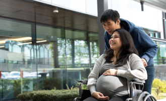 Pregnant woman and husband outside hospital.